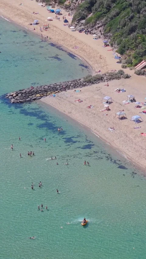 Aerial View of Half Moon Bay Beach with Tents and Swimmers in Black Rock Stock-Footage 327911156