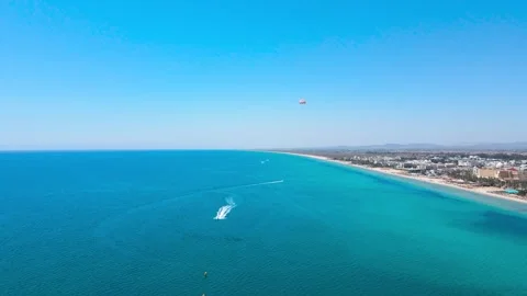 Aerial View of Hammamet's Coastal Paradise with Parasailing Adventure Stock Footage 305018564