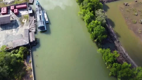 Aerial view of the harbor area of fuel tankers on a river close to the sea Stock Footage 246745920