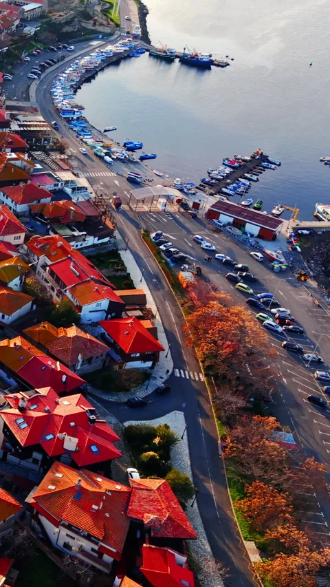 Aerial view of a harbor road and parking lot by the sea Vertical video. Stock-Footage 332344697