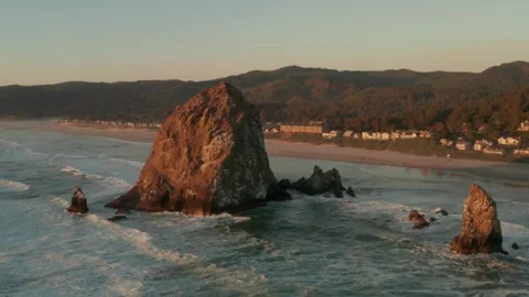 Aerial view of haystack rock and Cannon Beach Oregon at golden hour sunset. Stock Footage 337681052