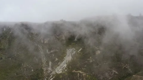 Aerial view that is heading towards a cliff while clouds cover the view Stock Footage 142755417