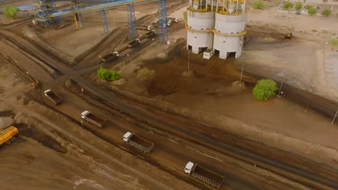 Aerial view of heavy dump trucks transporting coal at the THAR Engro Mining site Stock-Footage 344056158