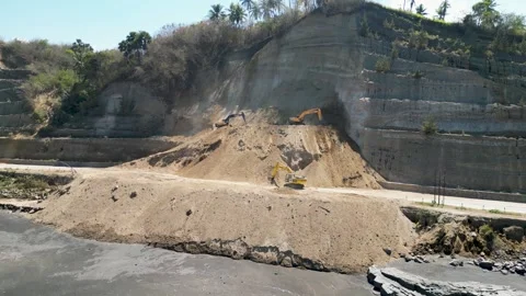 Aerial view of heavy excavators clearing a massive landslide Stock Footage 345197576