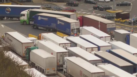 Aerial view of heavy freight trucks and semi trailers waiting in a long queue 库存影片 346505489