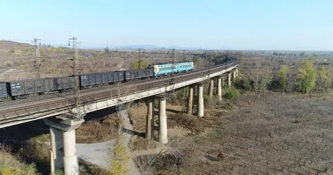 Aerial View of Heavy Loaded Cargo Train Runs on Railway Bridge Stock Footage 119489904