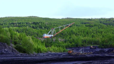 Aerial View of Heavy Machinery Operating in a Green Landscape Surrounded by Stock Footage 282736164