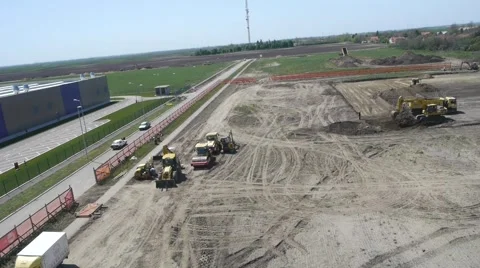 Aerial view on heavy machines preparing ground for new factory foundation Stock Footage 46750159