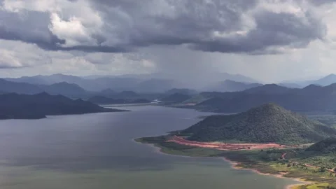 Aerial view of heavy rain clouds over mountain reservoir signaling rising water Stock Footage 314817367