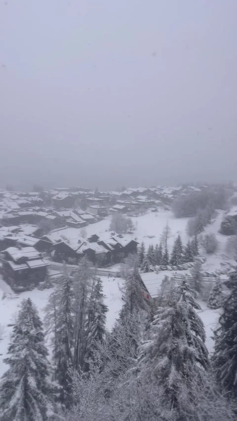 Aerial view of heavy snowing day on French alps, over le Praz village Stock Footage 334427140
