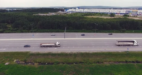 Aerial view of heavy traffic using busy freeway in the hills outside a city Video stock 92596217