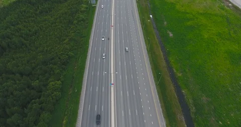 Aerial view of heavy traffic using busy freeway in the hills outside a city Video stock 92596492