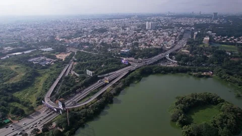 Aerial view of Hebbal Flyover and lake surrounded by greenery in Bengaluru .. Stock Footage 339560132