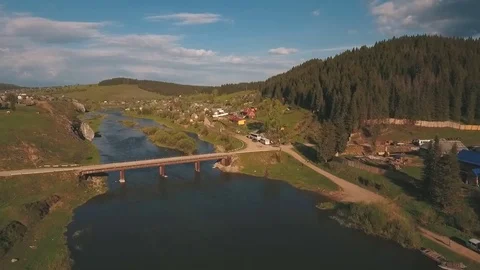 Aerial view from a height on the river and village near a forest Stock Footage 77168391