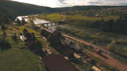 Aerial view from a height on the river and village near a forest Stock Footage 77168442
