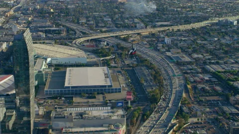 Aerial view of helicopter flying over city highway during the day in Los Angeles Stock Footage 199457082