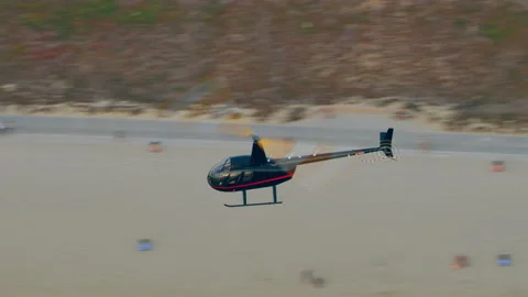 Aerial view of helicopter flying over ocean and beach during day in Los Angeles, Stock Footage 199458982