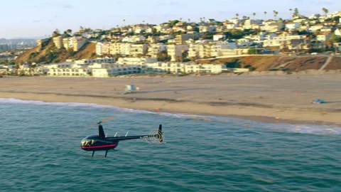 Aerial view of helicopter flying over Malibu beach during golden hour in Los Ang Stock Footage 199459293