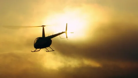 Aerial view of helicopter flying over mountains into the clouds during beautiful Stock Footage 199459707