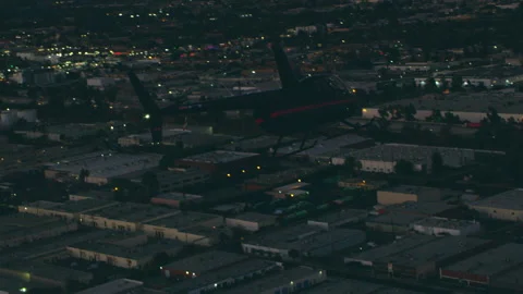 Aerial view of helicopter flying over city highway with mountain peaks in backgr Stock Footage 199459989