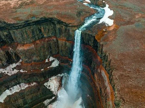 Aerial view on Hengifoss waterfall with red stripes sediments in Iceland. Stock Photos