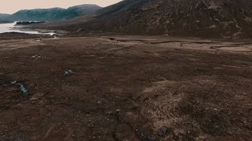 Aerial View of a Herd of Deer Running in a Barren Mountain Landscape Stock Footage 85754284