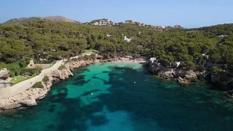Aerial view of hidden beach in turquoise bay, rocky coastline, Mallorca Stock Footage 284875480