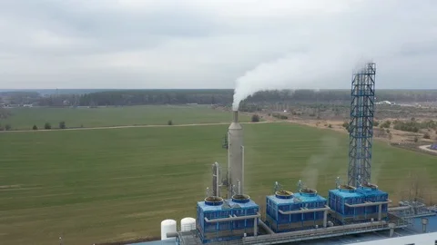 Aerial view of high chimney pipes with grey smoke from coal power plant. Prod Stockbeeldmateriaal 125982753