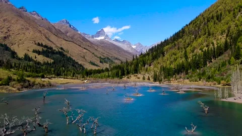 Aerial view of high mountain blue lake mountain forest canyon rock distant Stock Footage 337926429