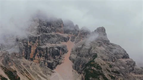 Aerial view of high mountain range covered with clouds in Dolomites, Italy Stock Footage 325035281