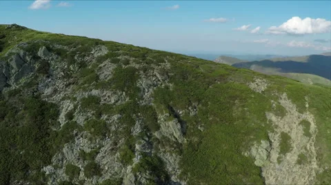 Aerial view of high mountain side, sunset light Stock Footage 68417024