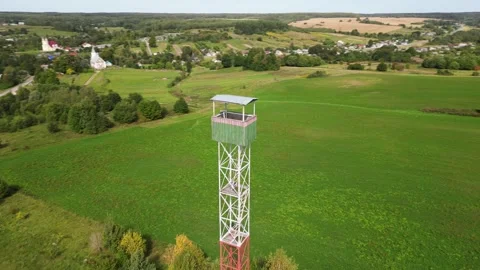 Aerial view of a high observation tower in the field. A panoramic drone flyby Stock Footage 287755428