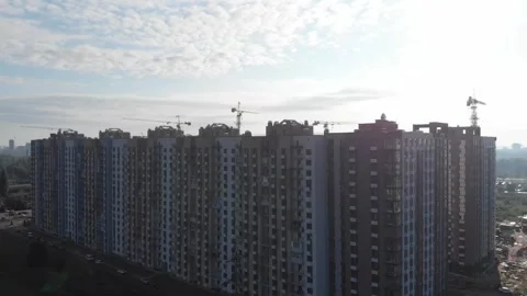 An aerial view of a high-rise construction site. Construction of a new residenti Stock Footage 260480331