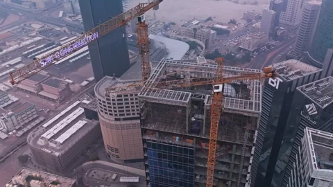 Aerial View of High-Rise Construction with Tower Cranes in Modern Cityscape Stock Footage 325846066