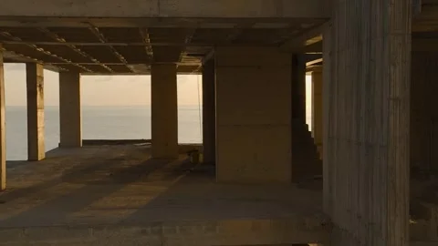 Aerial View: A high-rise structure on the coastline rises with a clear view of Stock Footage 296078425