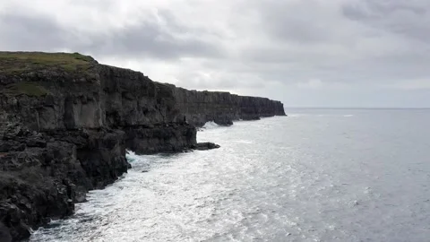 Aerial view high rock cliffs, ocean waves break on cliffs. Power of ocean 動画素材 167254557