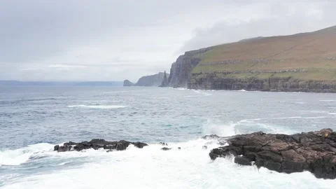 Aerial view high rock cliffs, ocean waves break on cliffs. Wild nature, wildlife 動画素材 167308079