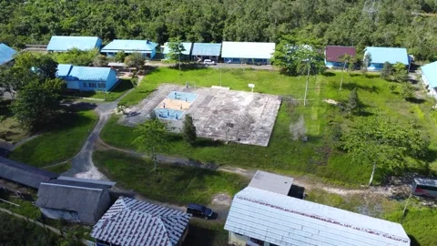 Aerial view of high school building and students playing soccer on basketba.. Stock Footage 310973554
