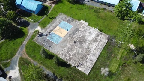 Aerial view of high school building and students playing soccer on basketba.. Stock Footage 310974277