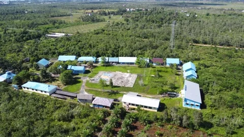 Aerial view of high school building and students playing soccer on basketba.. Stock Footage 310974404