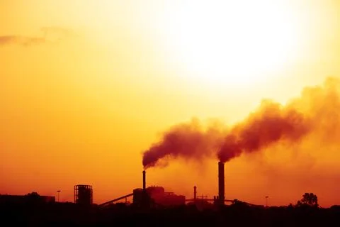 Aerial view of high smoke stack with smoke emission. Plant pipes pollute at.. Stock Photos