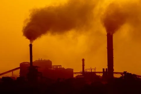 Aerial view of high smoke stack with smoke emission. Plant pipes pollute at.. Stock Photos