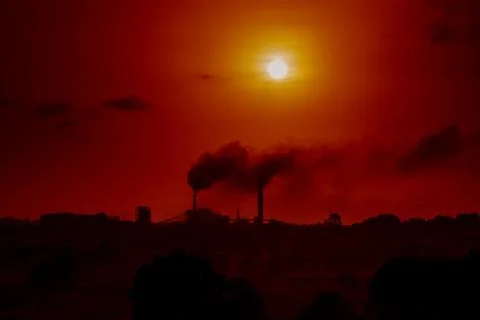 Aerial view of high smoke stack with smoke emission. Plant pipes pollute at.. Stock Photos