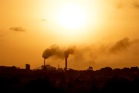 Aerial view of high smoke stack with smoke emission. Plant pipes pollute at.. Stock Photos