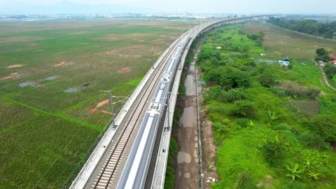 Aerial view of the High speed orange train on the railway station. High Stock Footage 232874751