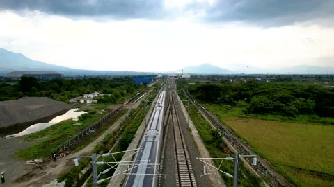 Aerial view of the High speed orange train on the railway station. High Stock Footage 232874763