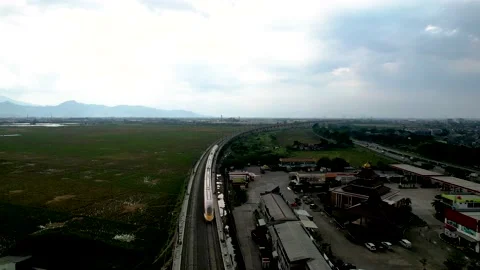 Aerial view of the High speed orange train on the railway station. High Stock Footage 233003418