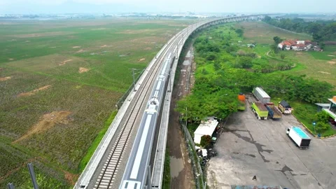 Aerial view of the High speed orange train on the railway station. High Stock Footage 233003860