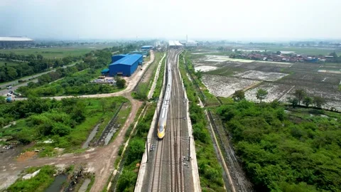 Aerial view of the High speed orange train on the railway station. High Stock Footage 233004054