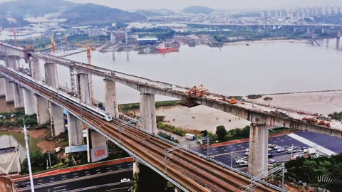 Aerial view of a high-speed train crossing a complex road junction Video stock 98091239